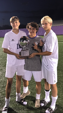 Josiah Blackerby, Owen Chandler, and Cameron Connell hold the O-Cup. 