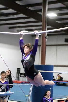 Junior Avery DeHart competes on the bars.