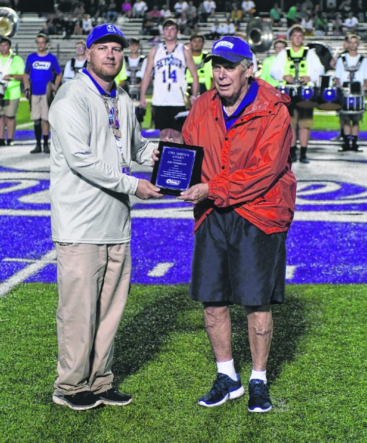 Seymour High School assistant athletic director Dave Urbanski presents former football coach Joe Goodman with the Owls Service Award at Bulleit Stadium on Sept. 7, 2018.