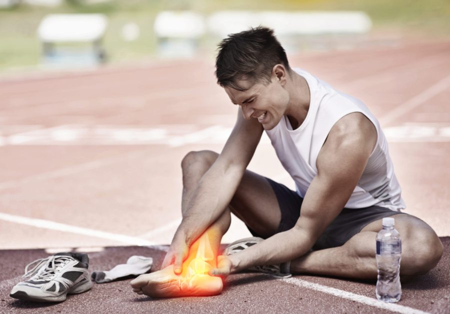 Shot of a young athlete holding his leg in pain