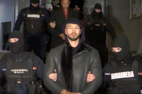 Andrew Tate, a prominent manosphere figurehead, being detained by Romanian police on alleged charges of rape, human trafficking, and organized crime.
